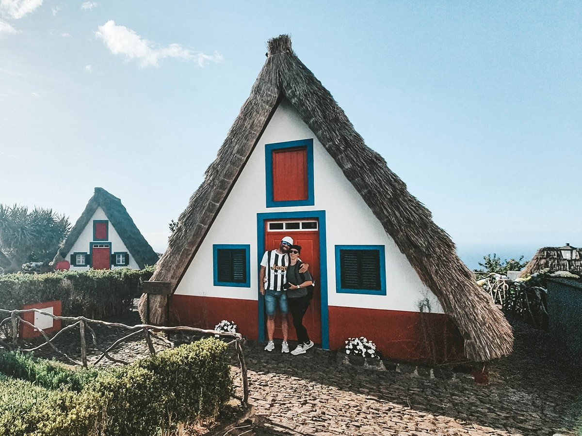 Traditional triangular shaped houses coloured in white blue and red in Santana