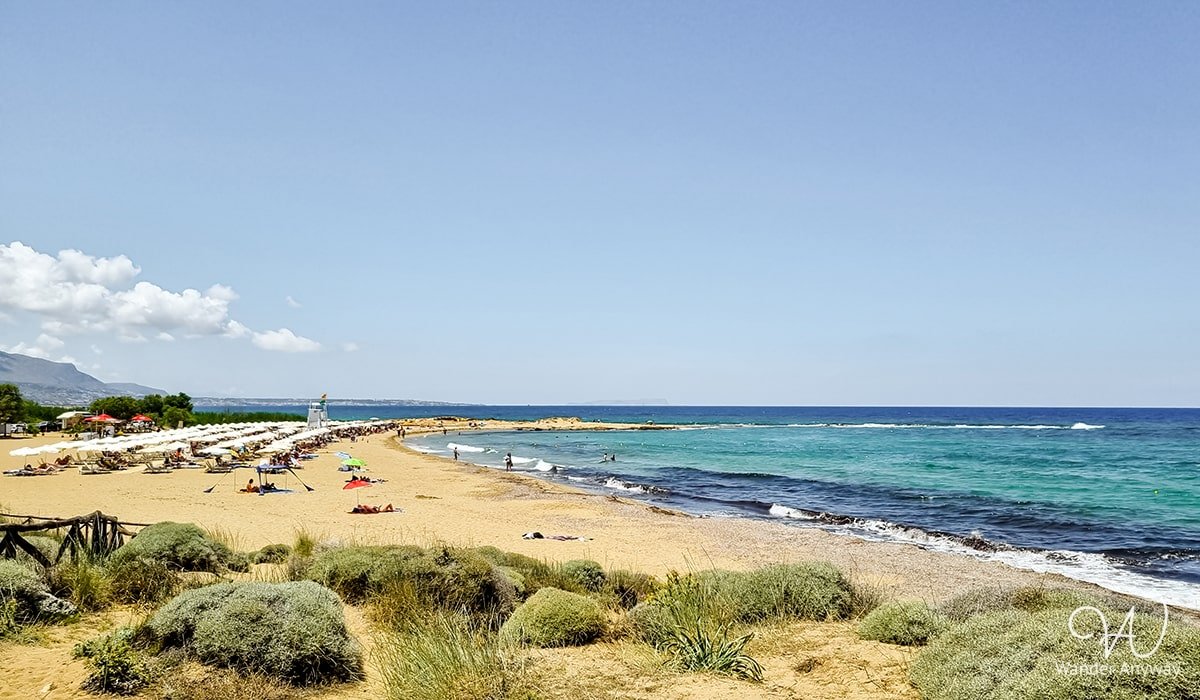 Family-friendly Potamos Beach with calm, shallow waters, located near the Malia archaeological site. (Beaches to Discover in Rethymno and Heraklion)