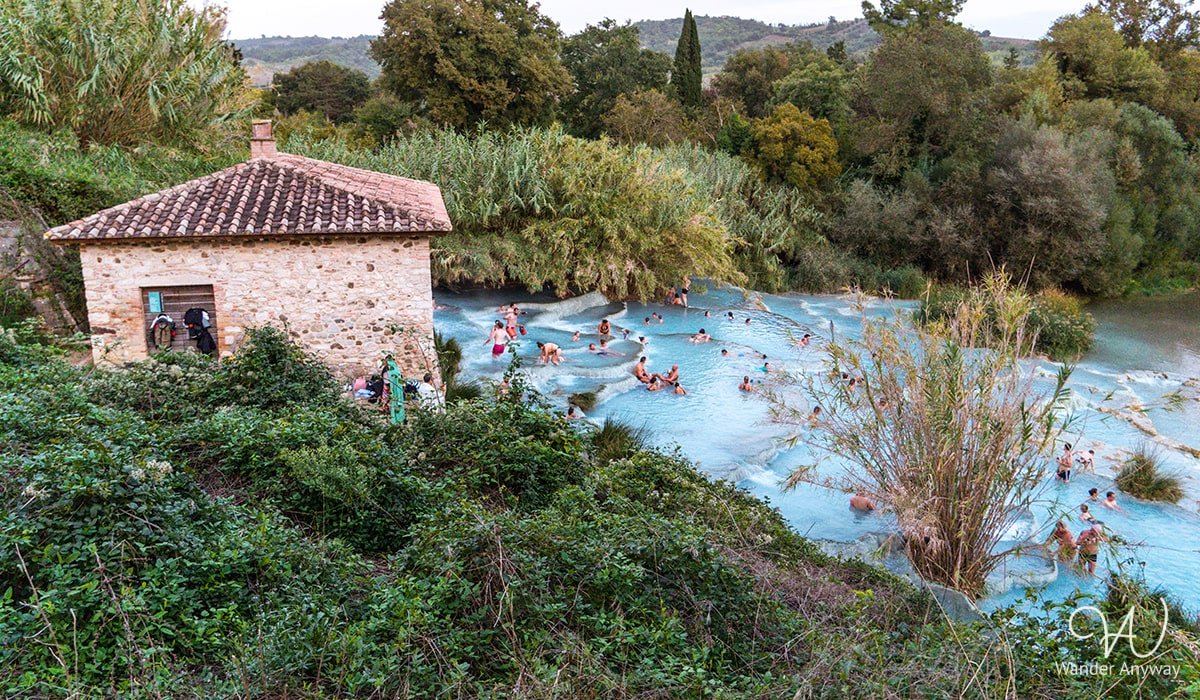 People soaking in Cascate del Mulino’s natural hot springs