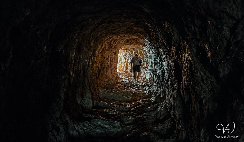 Dark tunnel section of the Peñón de Ifach hike leading toward the summit