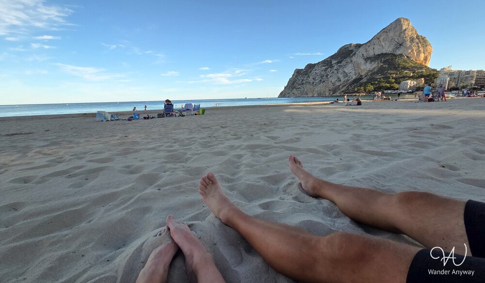 Relaxing on the sand at Calpe Beach with a view of Peñón de Ifach