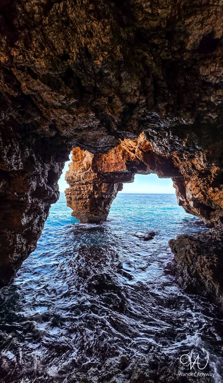 Sea cave at Cala del Moraig with crystal-clear turquoise water