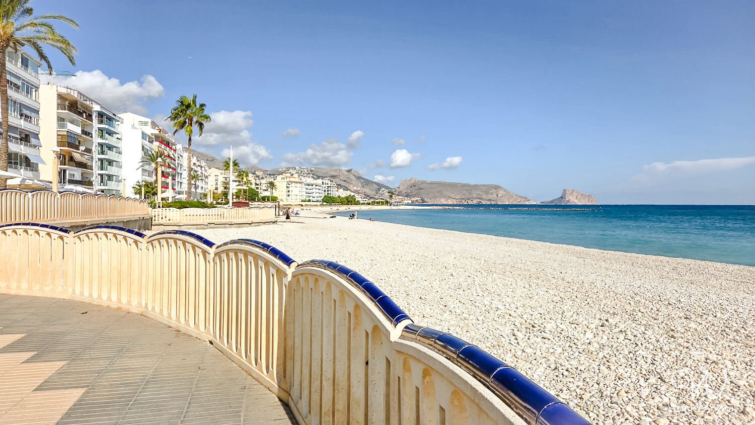 Pebble beach and seafront promenade at La Roda Beach in Altea