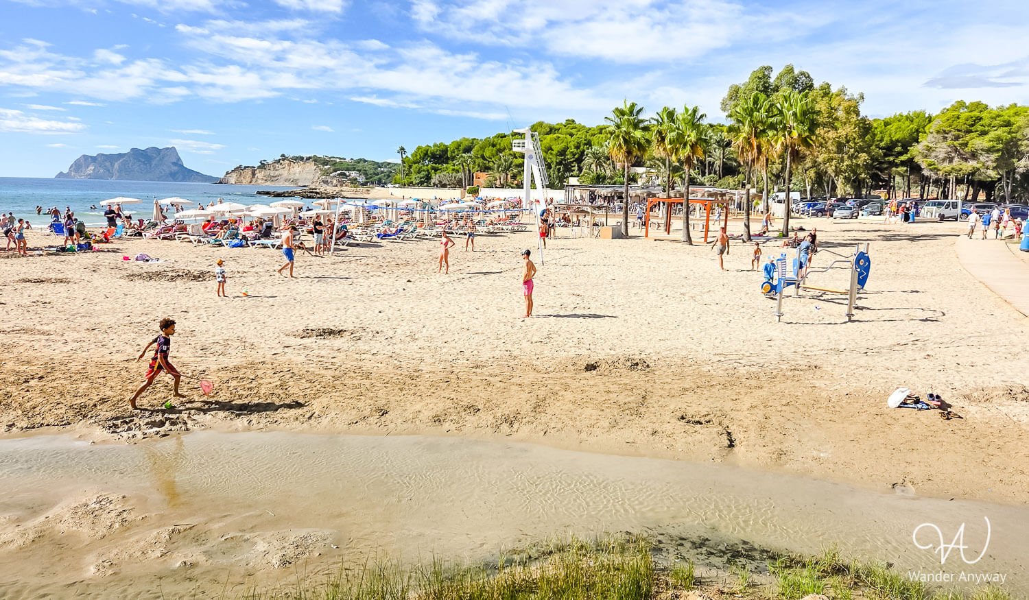 Sandy beach and calm water at L'Ampolla Beach in Moraira